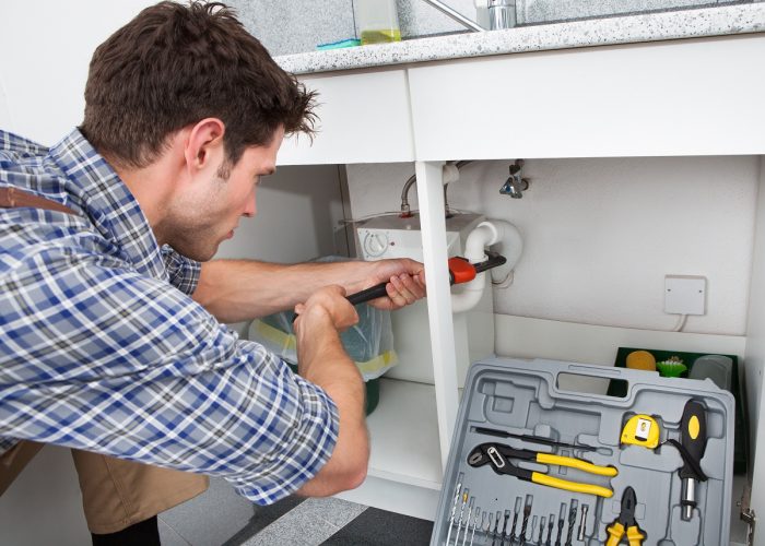 Plumber Fixing Sink In Kitchen plumber fixing kitchen